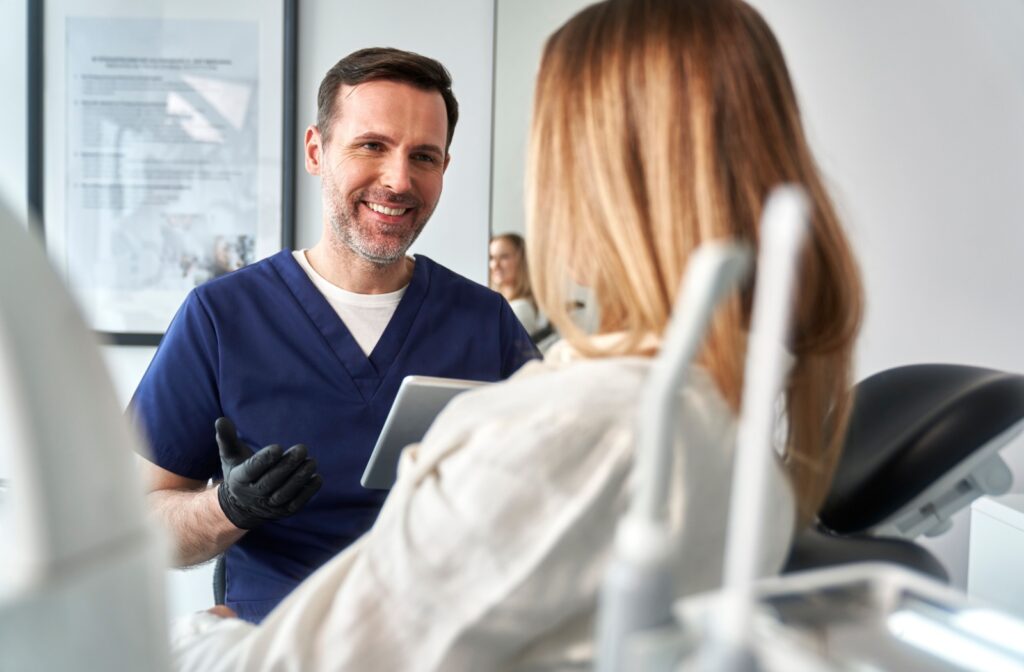 Dentist discussing laser snoring treatment benefits with a patient.