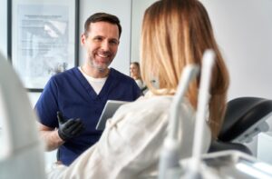 Dentist discussing laser snoring treatment benefits with a patient.